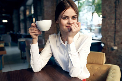 Young woman drinking coffee cup