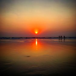 Scenic view of beach against sky during sunset