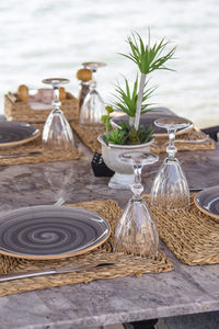 Beautiful served table of a modern cafe by the sea with dishes and flowers