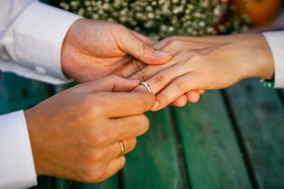 Close-up of man proposing woman over table