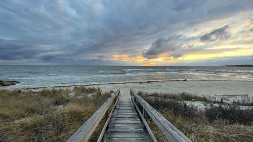 Scenic view of beach against sky during sunset