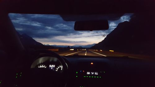 Close-up of car windshield against sky during sunset