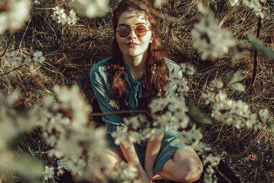 Woman sitting amidst tree at park