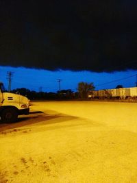 View of field against cloudy sky
