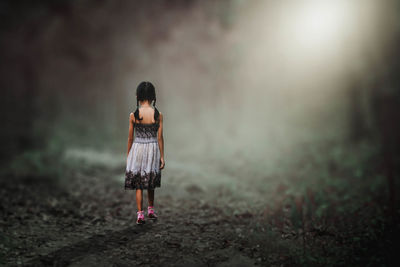 Full length of woman standing on field