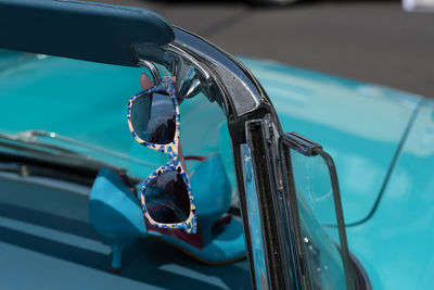 Close-up of car with sunglass and highheels 