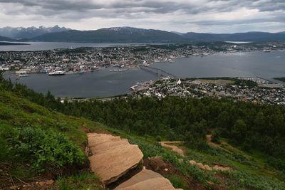 High angle view of townscape by sea against sky