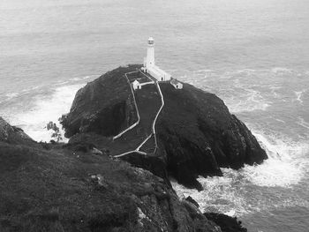 High angle view of lighthouse on rock in sea