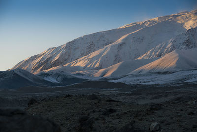 Scenic view of snowcapped mountains against clear sky
