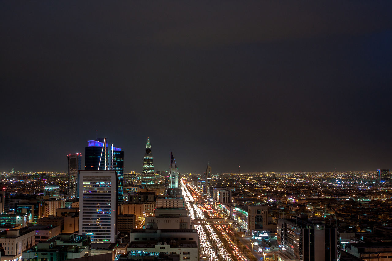 VIEW OF ILLUMINATED CITYSCAPE AT NIGHT