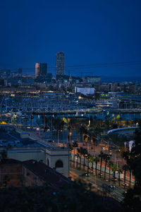 Barcelona city seen from the mountain in the blue hour with traffic and buildings