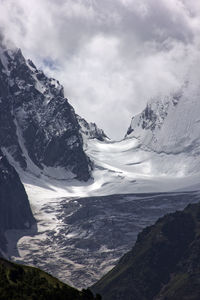 Scenic view of lake by mountains against sky