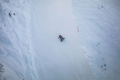 People skiing on snow covered landscape