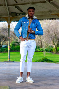 Portrait of young man standing on road
