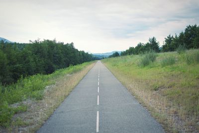 Empty road along countryside landscape