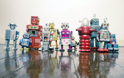 Row of toys on floor against white background