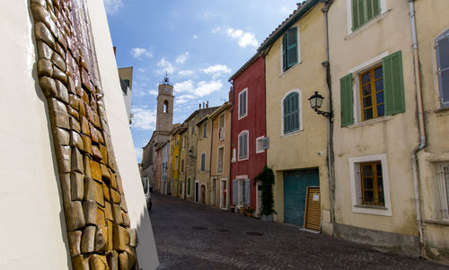 Empty road amidst buildings in town