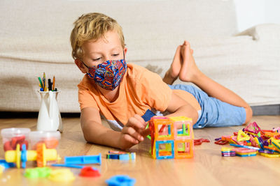 Boy playing with toy at home