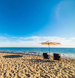 Scenic view of beach against blue sky