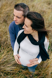 Pregnant couple standing on grass