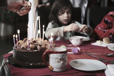 Close-up of illuminated candles on table