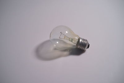 Close-up of light bulb over white background