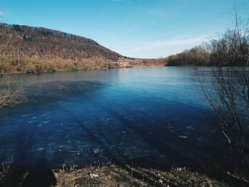 Scenic view of lake against blue sky