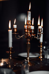 Close-up of illuminated candles on table