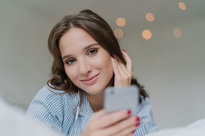 Portrait of young woman using mobile phone