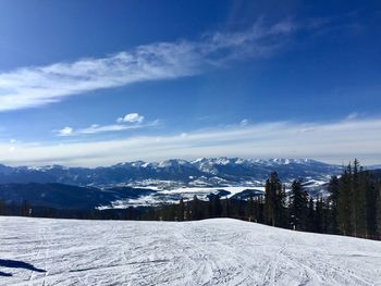 Scenic view of snowcapped mountains against sky