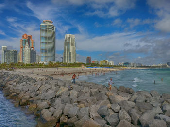 Panoramic view of sea and city against sky