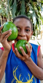 Midsection of boy holding fruit