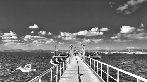 Pier on sea against sky