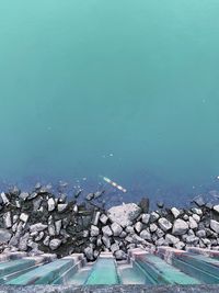 Aerial view of sea by rocks