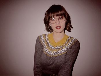 Portrait of young woman against white background