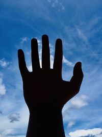 Low angle view of silhouette hand against sky