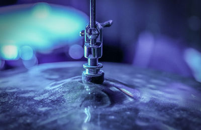 Close-up of water falling on glass table