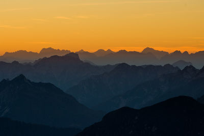 Scenic view of silhouette mountains against sky during sunset