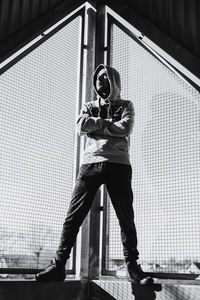 Full length of man standing by fence