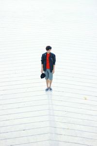 High angle view of young man standing on walkway