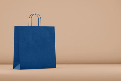 Close-up of shopping bag against white background