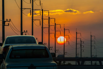 Cars against sky during sunset