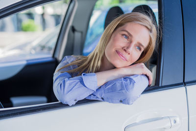 Close-up of woman sitting car