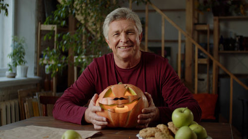 Portrait of man with pumpkin
