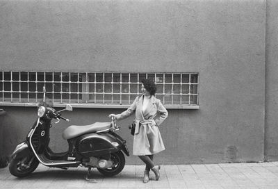 Woman with umbrella on street in city