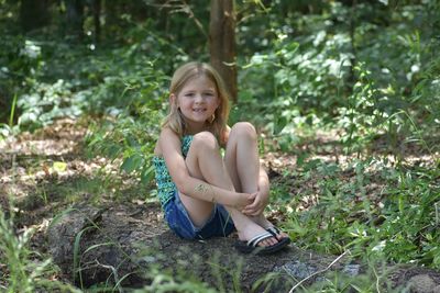 Portrait of smiling girl sitting on land