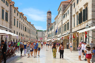 Tourists walking in stradun main street in dubrovnik, croatia.