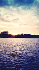 Scenic view of lake against sky at sunset