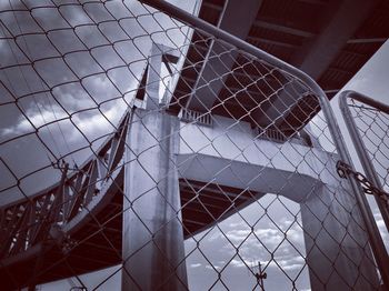 Low angle view of building seen through fence