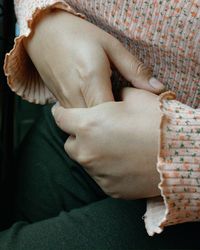 Midsection of woman lying on sofa